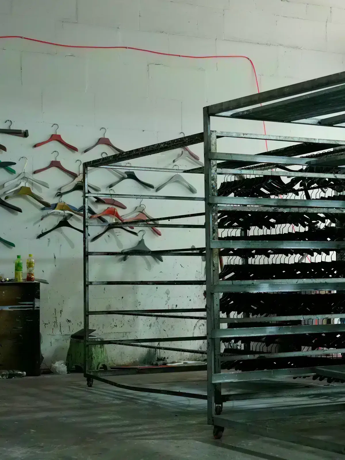 Painted hangers drying on racks in the Fanan Display workshop