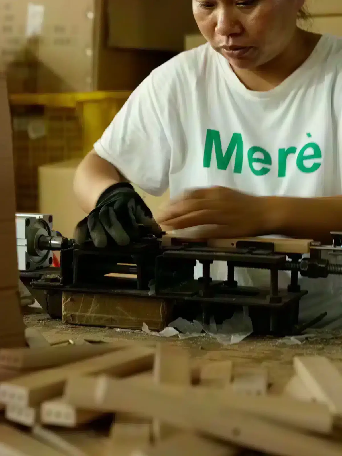 Worker assembling hooks and clips onto hangers at Fanan Display